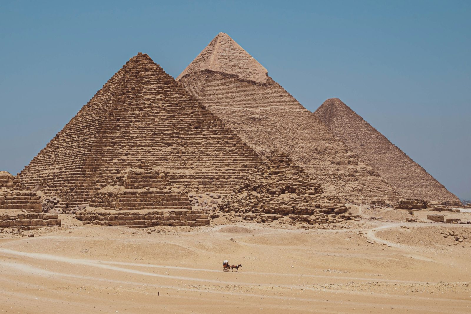 The pyramids of Giza under a clear blue sky